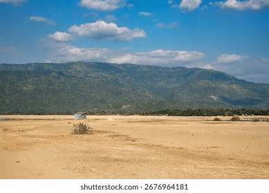 Sandy Plain with Distant Mountains Under a Clear Blue Sky