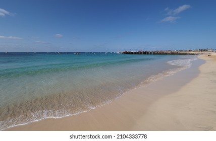 Sandy seaside with boats on Atlantic Ocean in african Santa Maria town, Sal island in Cape Verde clear blue sky in 2019 warm sunny spring day on April - Shutterstock ID 2104333778