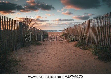 Sandy walkway down to the beach and ocean during a beautiful sunrise