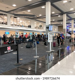 Sanford, FL USA - May 13, 2021:  People Waiting To Get Their Tickets At An Allegiant  Airline Checkin Counter At A Busy  Airport.