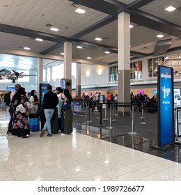 Sanford, FL USA - May 13, 2021:  People Waiting To Get Their Tickets At An Allegiant  Airline Checkin Counter At A Busy  Airport.