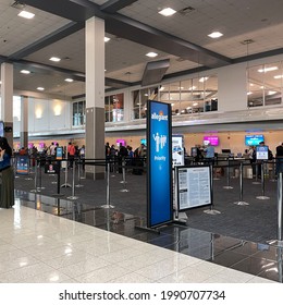 Sanford, FL USA - May 13, 2021:  People Waiting To Get Their Tickets At An Allegiant  Airline Checkin Counter At A Busy  Airport.