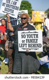 SANFORD, FL-MACRH 26:  A Female Protester Holds A Sign In Support Of Trayvon Martin On March 26, 2012 In Sanford Florida.