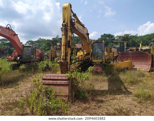Sangata, Indonesia - August,2020: The graves of\
various kinds of coal mining production equipment that are no\
longer suitable for\
operation