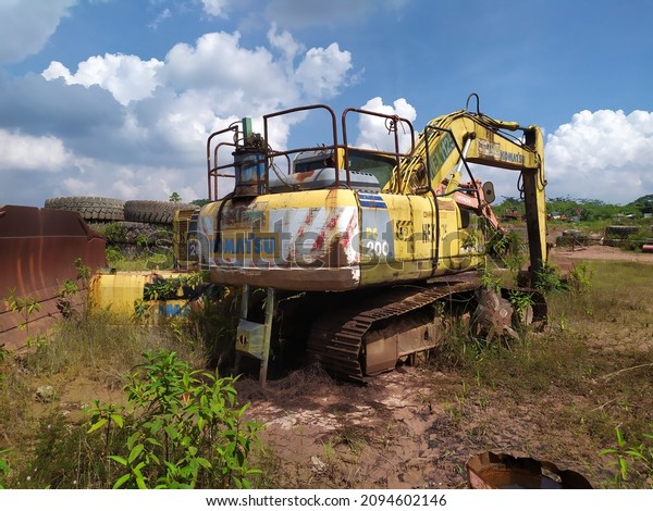 Sangata, Indonesia - August,2020: The graves of\
various kinds of coal mining production equipment that are no\
longer suitable for\
operation