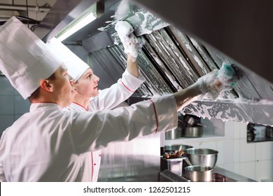 Sanitary day in the restaurant. Repeats wash your workplace. Cooks wash oven, stove and extractor in the Restaurant - Powered by Shutterstock