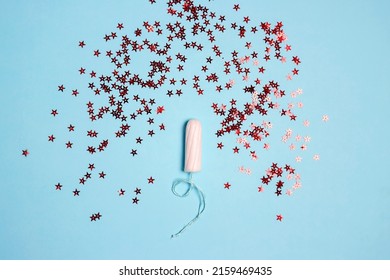 Sanitary Female Tampon With Red Glitter Stars On Blue Background. Menstruation Cycle Period, Woman Hygiene.