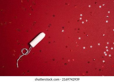 Sanitary Female Tampon With Red Glitter Stars On Red Background. Menstruation Cycle Period, Woman Hygiene.