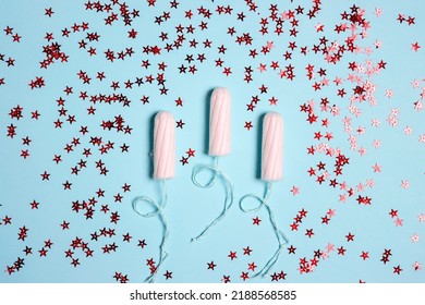 Sanitary Female Tampons With Red Glitter Stars On Blue Background. Menstruation Cycle Period, Woman Hygiene.