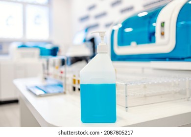 Sanitizer Production. A Bottle With A Blue Disinfection Liquid On A Table In The Lab.