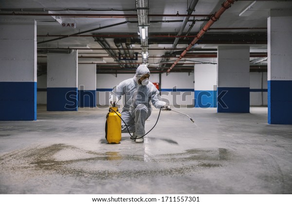 Sanitizing interior surfaces, garage. Cleaning and
Disinfection inside buildings, the coronavirus epidemic.
Professional teams for disinfection efforts. Infection prevention
and control of epidemic.

