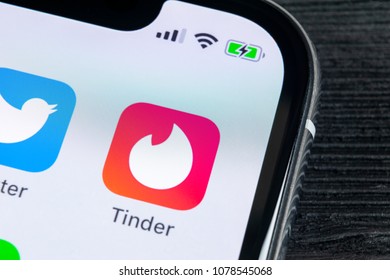 Sankt-Petersburg, Russia, April 27, 2018: Tinder application icon on Apple iPhone X screen close-up. Tinder app icon. Tinder application. Social media icon. Social network. 