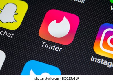 Sankt-Petersburg, Russia, February 26, 2018: Tinder application icon on Apple iPhone X screen close-up. Tinder app icon. Tinder application. Social media icon. Social network. 