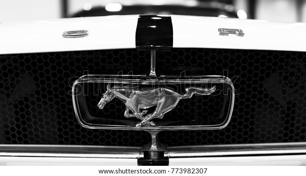 Sankt-Petersburg, Russia, July 21, 2017: Front view of\
Classic retro Ford Mustang GT logo with running horse. Car exterior\
details. Black and white. Photo Taken at Royal Auto Show  July, 21\
