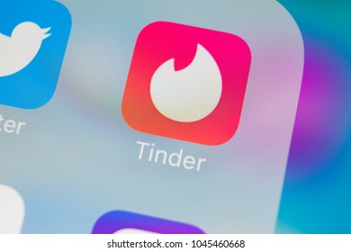 Sankt-Petersburg, Russia, March 13, 2018: Tinder application icon on Apple iPhone X screen close-up. Tinder app icon. Tinder application. Social media icon. Social network. 