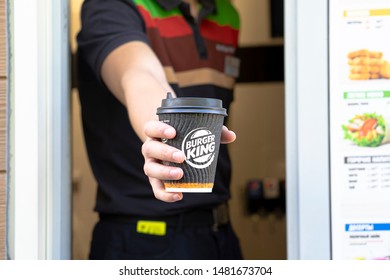 Sankt-Petersburg/Russia - August 18 2019: Burger King Worker Holding Cup With A Coffee. Hand With A Paper Cup Coffee To Go,  Through The Window Of Burger King Car Go,  Take Away Service.