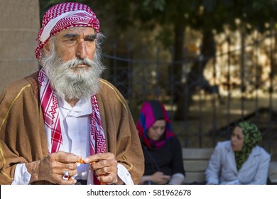 SANLIURFA, TURKEY - MAY 14, 2014: Local man in traditional dresses plays with his prayer beads in Sanliurfa, Turkey