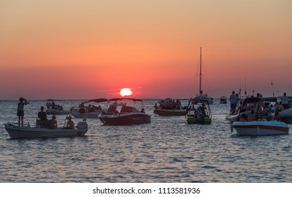 
Sant Antoni De Portmany, Balearic Islands, Spain - July 10, 2017: Sunset At Café Del Mar. People On Boats Gathered To See The Sunset. 