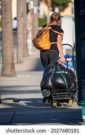 Santa Ana, CA USA 09-21-19 Homeless Woman Walking On City Street With Her Belongings 