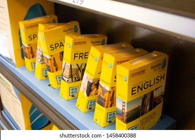 Santa Ana, California/United States - 06/08/19: Several Yellow Cases Of Rosetta Stone Language Education Software Bundles For Sale At A Local Bookstore