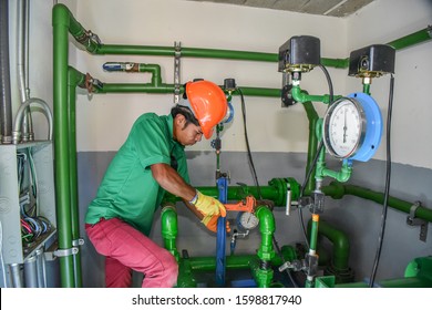 Santa Ana, San José/Costa Rica-11/22/19: hardworking latino handyman fixing water pump pipes