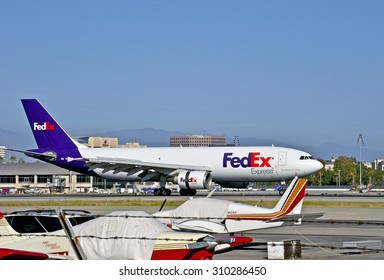 SANTA ANA/CALIFORNIA - AUGUST 17, 2015: FedEx Airbus A300 cargo jet taxiing on runway after landing at John Wayne International Airport in Santa Ana, California, USA