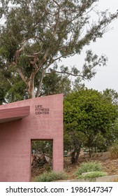 Santa Barbara, CA, USA - June 2, 2021: City College Facilities. Architectural Feature Of Red Life Fitness Center Building Under Green Foliage.