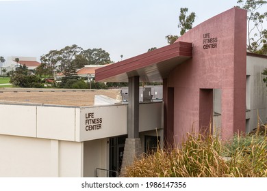 Santa Barbara, CA, USA - June 2, 2021: City College Facilities. Life Fitness Center Building In Beige And Red Stone. Green Foliage And Gray Sky.