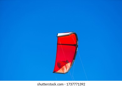 SANTA BARBARA, CA, USA - MAY 19, 2020: A Red Kite For Surfing Against Bright Blue Sky. 