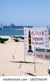 Santa Barbara, California / USA - June 1 2014:  Banner Protesting Nuclear Proliferation And Military Spending At West Beach, With The USS Reagan Aircraft Carrier Is The Distance