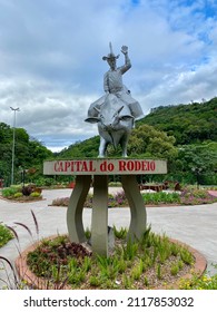 "Ibicaré, Santa Caterina  Brasil - January 21 2022: Statue of a cowboy sitting on top of a bull in the main square of Ibicaré town, Santa Catarina Brasil"