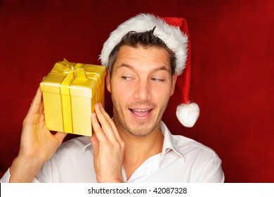 Santa  Christmas Guy In Red With Background Holding And Opening Golden Gift Present