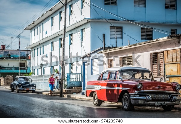 Santa Clara, Cuba - June 22, 2015: HDR - Street\
life view with a red american Chevrolet classic car - Serie Cuba\
Reportage