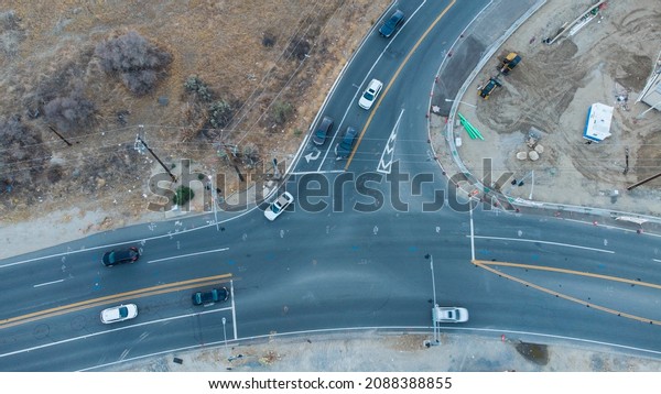 Santa Clarita Valley, California, USA\
- October 29, 2021:  Late afternoon drone shot of cars driving\
through the intersection at The Old Road and Calgrove Blvd\
.