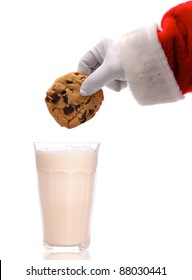 Santa Claus About To Dunk A Chocolate Chip Cookie Into A Glass Of Milk Over A White Background