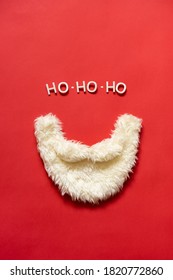 Santa Claus beard on a red background. Ho-ho-ho lined with letters