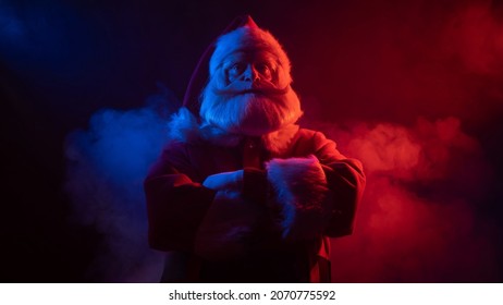 Santa claus in blue red smoke. Party for Christmas.