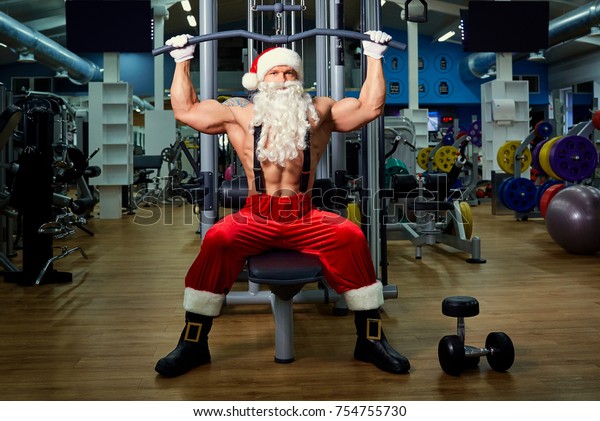 Papai Noel Bodybuilder treinamento no ginásio no dia de Natal.