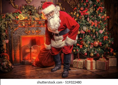 Santa Claus bring the sack with gifts for Christmas. The house is beautifully decorated for Christmas.