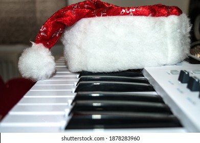 Santa Claus Cap On Piano Keys. Holiday Background.