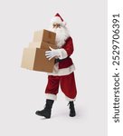 Santa Claus carrying delivery boxes filled with Christmas gifts, isolated on white background