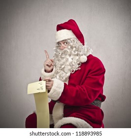 Santa Claus Checking The Gift List