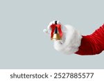 Santa Claus with Christmas bell on grey background