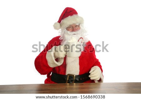 Santa Claus. Christmas Santa. Isolated on white. Room for text. Santa Claus holds a cup of Hot Coco with a Candy Cane and Whip Cream. Santa Loves Hot Coco and Cookies on Christmas. 