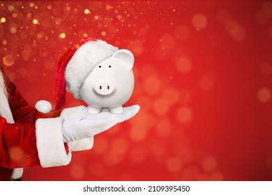 Santa Claus Christmas piggy bank money box. Festive saving concept