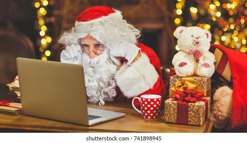 Santa Claus With A Computer Before Christmas
