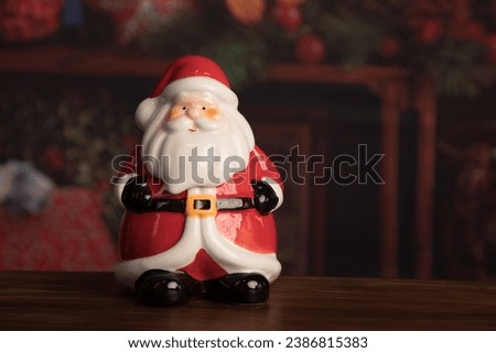 Santa Claus cookie jar Little Christmas holliday decoration toys on red background