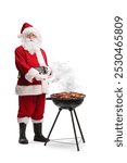 Santa claus cooking meat on a bbq isolated on white background