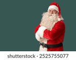 Santa Claus with crossed arms on green background