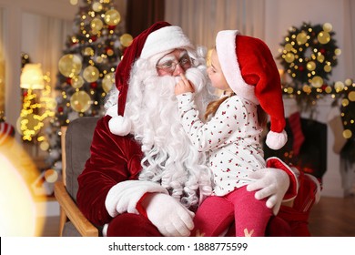 Santa Claus And Cute Little Girl In Room Decorated For Christmas